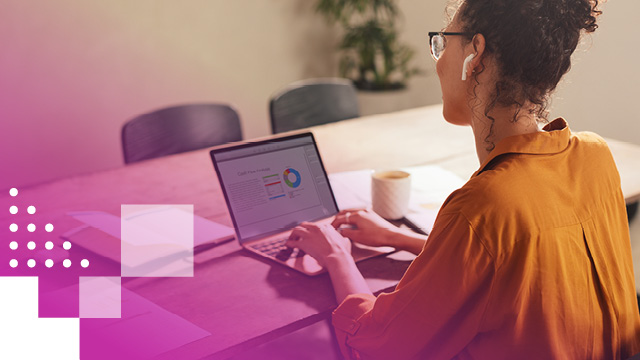 Woman sitting at a desk with a laptop